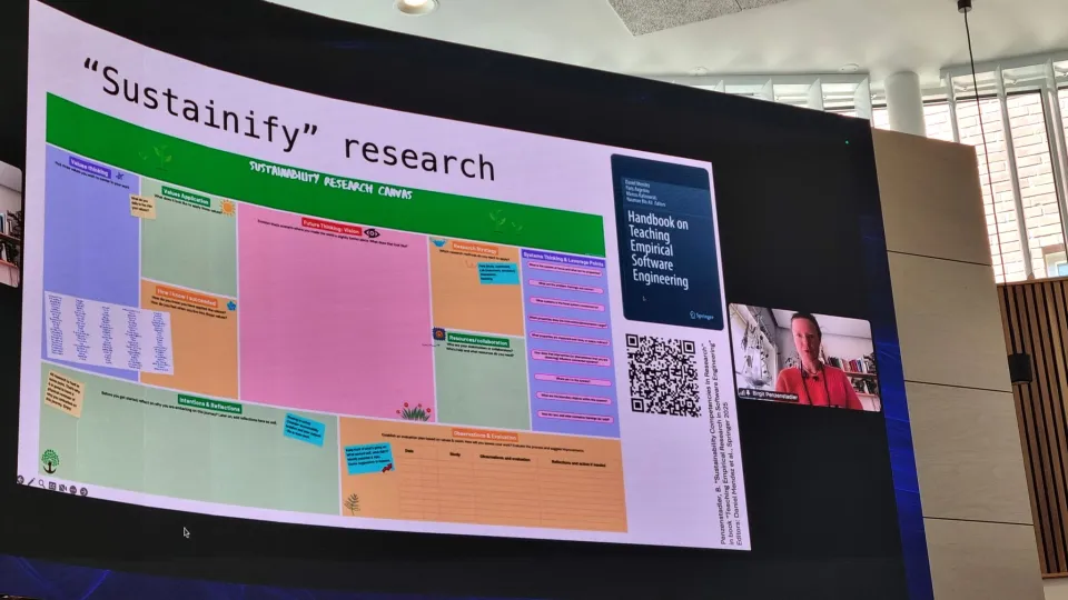 A large vaulted screen in a lecture hall. 